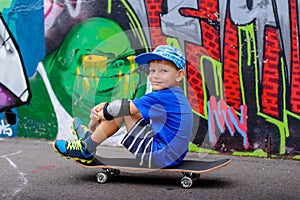 Young boy taking a rest at the skate park