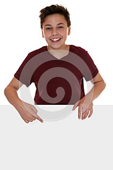 Young boy or teenager pointing on an empty banner with copyspace