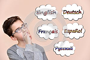 Young boy thinking which languages to learn photo