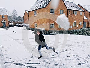 Young boy throwing a snowball outdoors