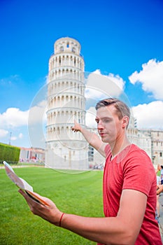 Young boy with toristic map on travel to Pisa. Tourist traveling visiting The Leaning Tower of Pisa.