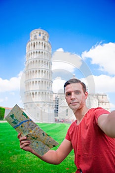 Young boy with toristic map on travel to Pisa. Tourist traveling visiting The Leaning Tower of Pisa.