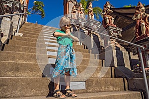 Young boy tourist in budhist temple Brahma Vihara Arama Bali