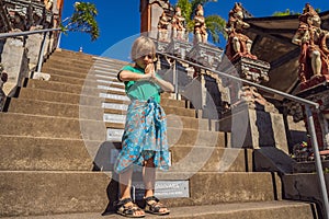 Young boy tourist in budhist temple Brahma Vihara Arama Banjar Bali, Indonesia