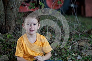 Young Boy with Tractor in Background