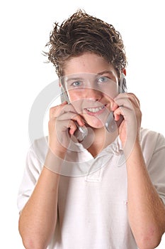 Young boy on two cell phone vertical