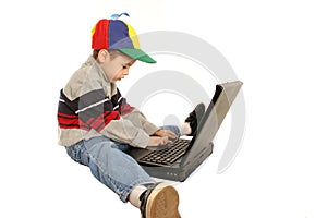 Young boy types on laptop