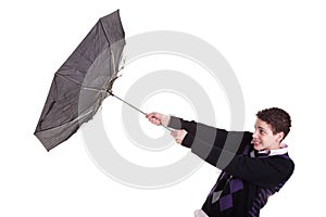 Young boy with an umbrella turned by the wind