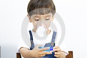 Young Boy Using Inhaler