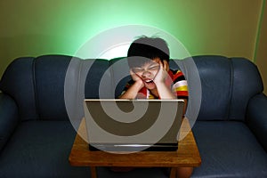 Young boy using a laptop computer and smiling