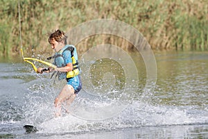 Young boy wakeboarding