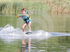 Young boy wakeboarding