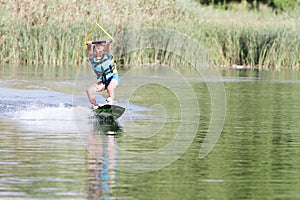 Young boy wakeboarding