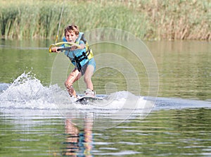 Young boy wakeboarding photo
