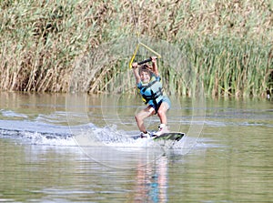 Young boy wakeboarding