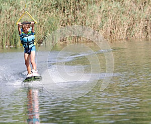Young boy wakeboarding