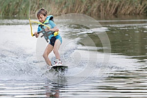 Young boy wakeboarding