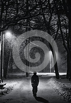 A young boy walking alone on a dark street