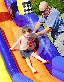 Young boy on water slide