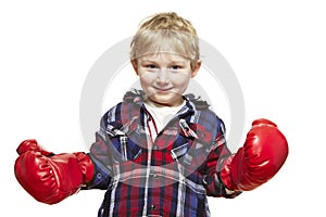 Young boy wearing boxing gloves smiling