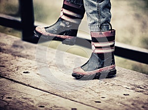 Young Boy Wearing Fireman Rain Boots