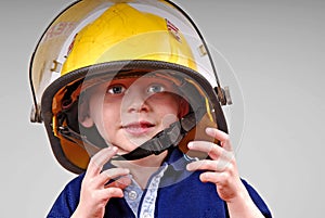 Young Boy Wearing Fireman's Helmet