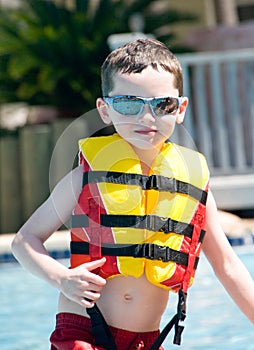 Young boy wearing flotation device