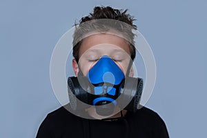 Young boy wearing gasmask, respirator portrait