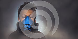 Young boy wearing gasmask, respirator portrait