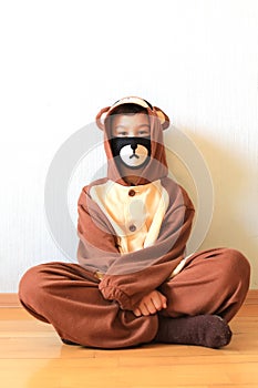 Young boy wearing hand-made mask and outfit at home