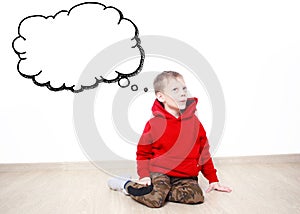 Young boy wearing red hoodie is daydreaming thinking about something, text cloud with space for your text