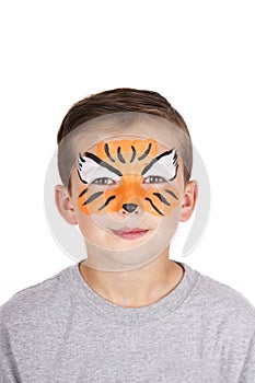 Young boy wearing tiger carnival face paint