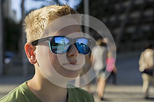 Young boy wearing trendy sunglasses