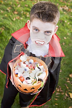 Young boy wearing vampire costume on Halloween