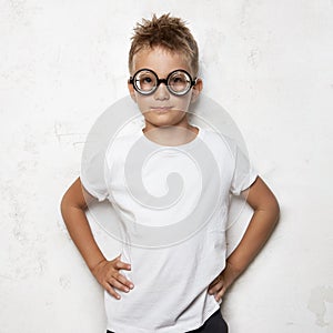 Young boy wearing white tshirt and black photo