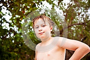 Young boy with wet hair comes out