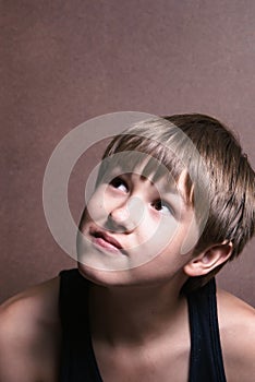 Young boy wondering what kind of truble he can stir up