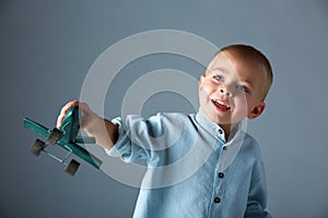 Young boy with wooden airplane