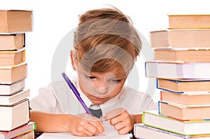 Young boy writing and books