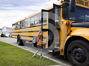 Young boy and yellow school bus