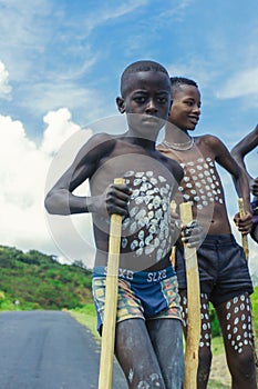 Young Boys of Benna Tribe with Traditional Body Painting on the Long Wooden Sticks posing for the picture