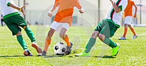 Young boys children in uniforms playing youth soccer football game