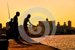 Young boys fishing at sunset in Havana