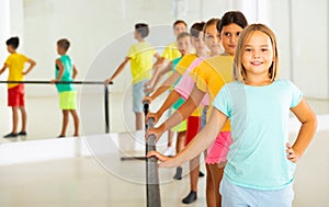 Young boys and girls training ballet moves