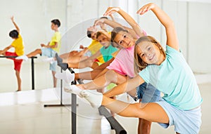 Young boys and girls training ballet moves