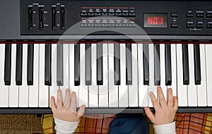 Young boys hands on an electronic piano or keyboard