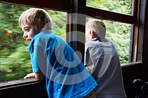 Young boys looking out train window