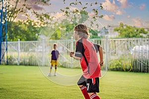 Young boys playing football soccer game. Running players in uniforms