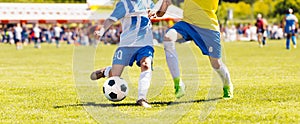 Young boys playing soccer game. Kids having fun in sport. Happy kids compete in football game