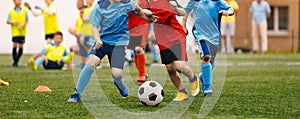 Young boys playing a soccer game. Kids having fun in sport. Happy kids compete in football games